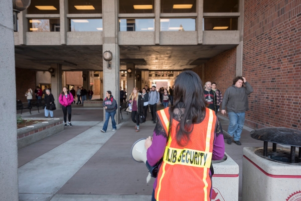 Floor evacuation coordinator wearing orange vest by Meriam Library
