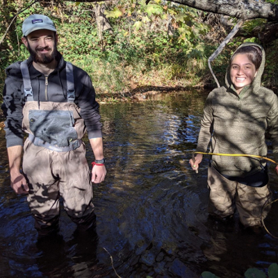 two studentes in the creek conducting experiments