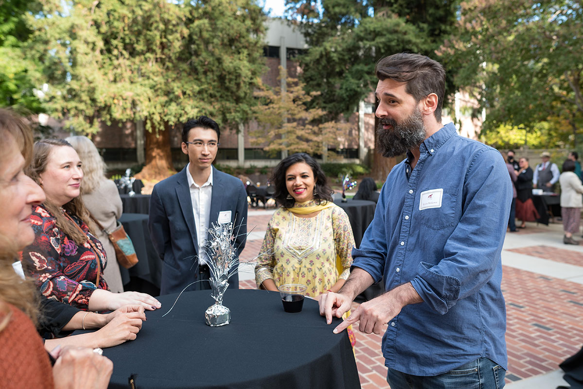 Faculty conversating at cocktail table during the 2022 tenure and promotion faculty reception.