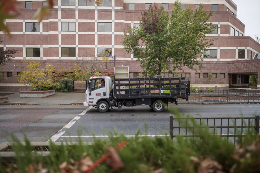 A moving services truck drives on campus