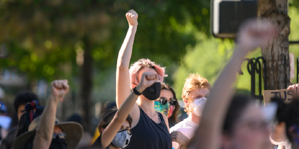 People raise their fists at a protest