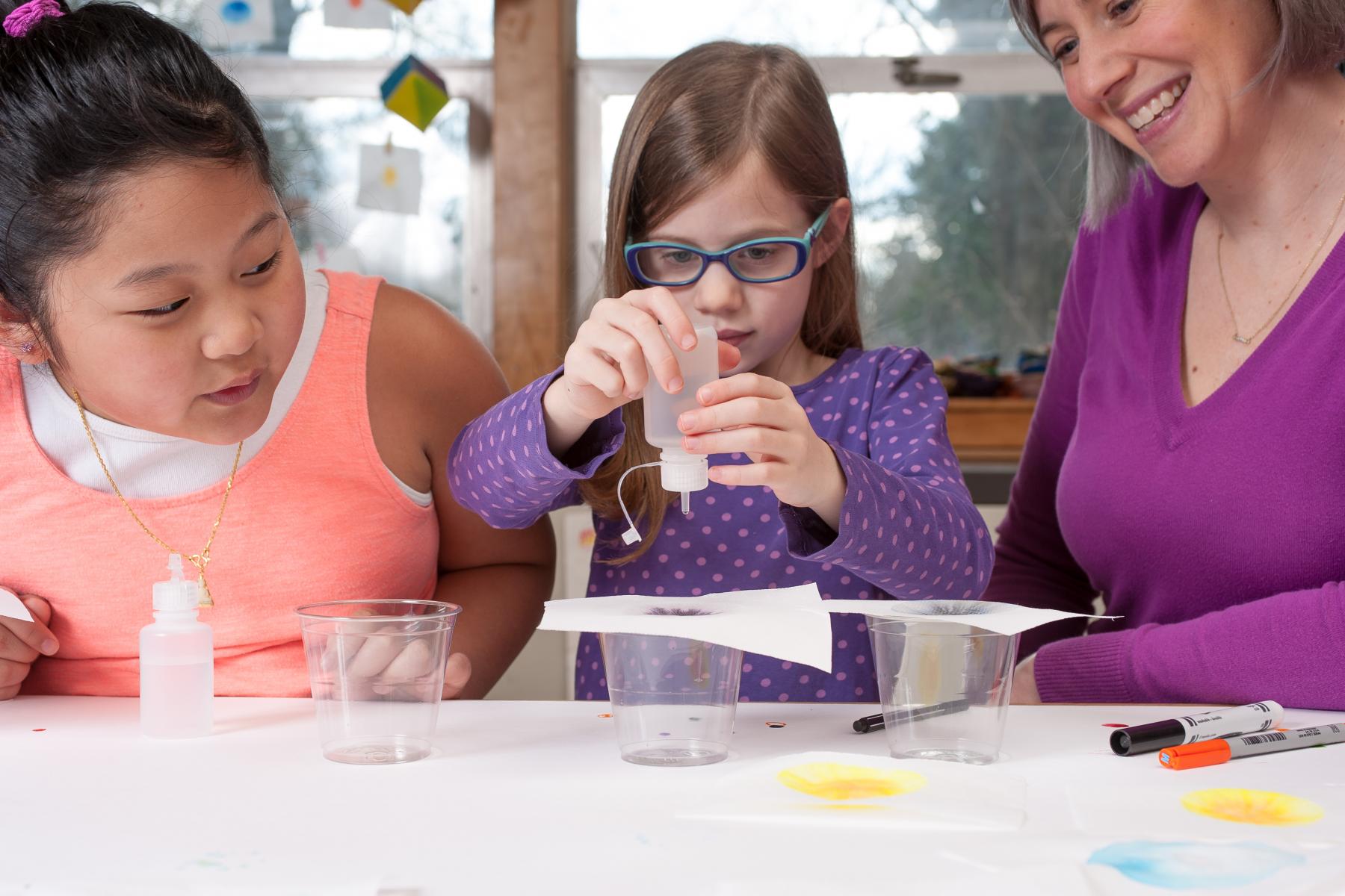 Three children work on a science project together