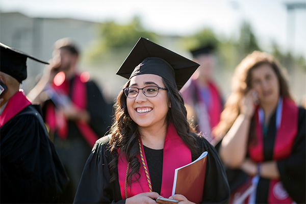 smiling graduate with grad cap