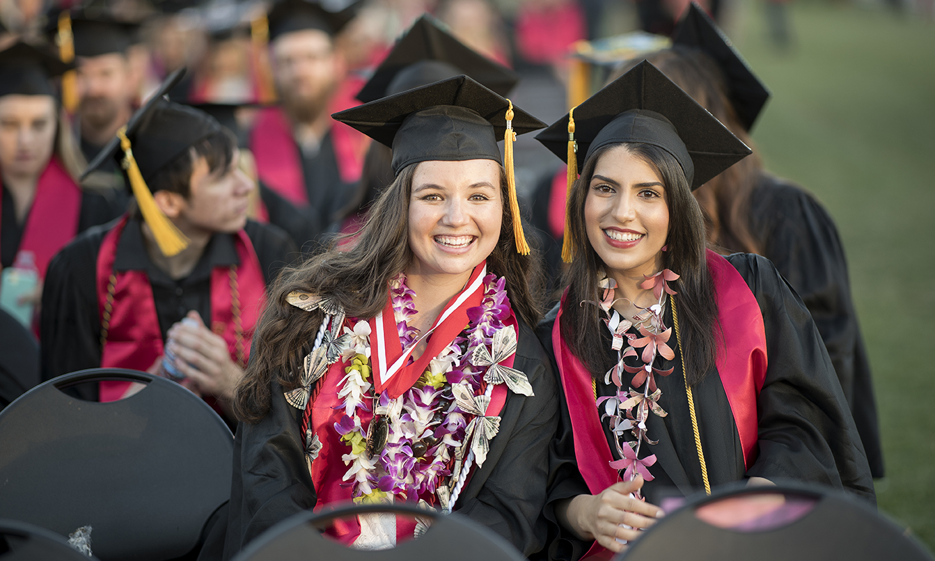 two graduating students at the Chico State graduation ceremony.