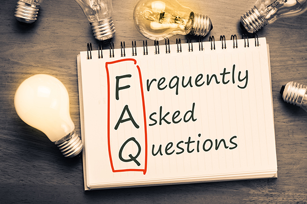 Notepad that says FAQ surrounded by light bulbs 