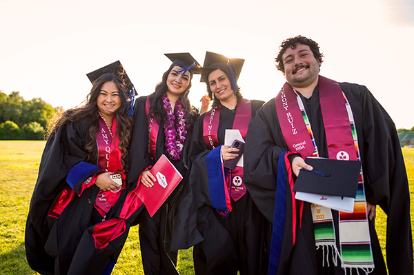 four master's students at commencement
