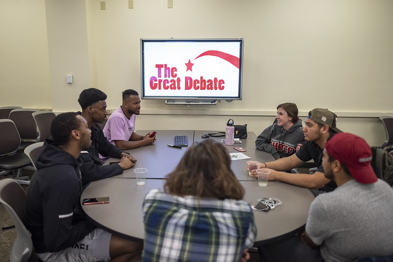 Students in Cookies and Conversations as they engage in a day of presentations and debates that stresses active listening, respectful exchange, and collaborative civic learning through civil discourse during the Great Debate