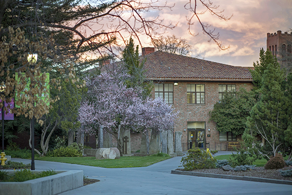 A sunset is seen behind art building Ayres Hall 