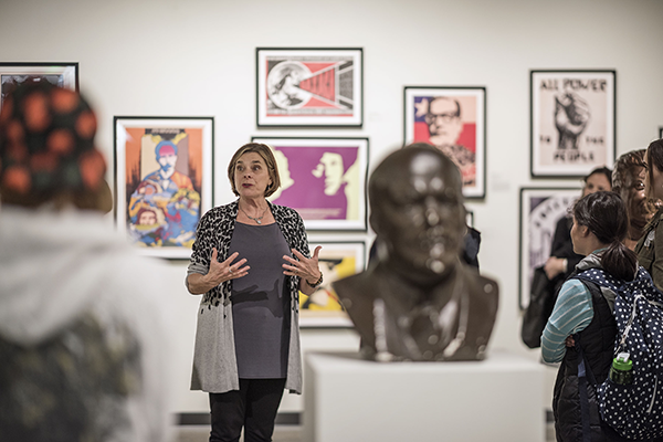 History faculty Kate Transchel (center) leads students in Art History and Russian History class combo on a tour the exhibition “Revolutionizing the World? The Russian Revolution at its Centenary.”, installed in the Jacki Headley University Art Gallery