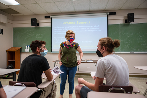 Professor Hannah Burdette working with two students in her Spanish class
