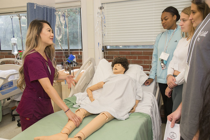 Students and volunteer stand around a dummy used by nursing students. The people in the image are Kyle McCarty, Lauren Jackson, Caitlyn, Ashlee Douglas, Areej Anwer, and Julia Chun. The second annual Pre Nursing Conference is hosted by Chico State Pre Nursing Club