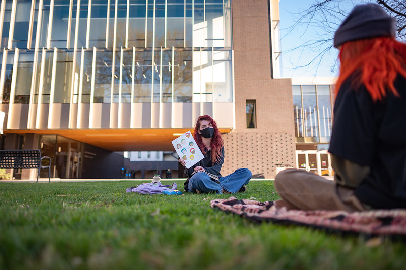 Seven Mills (left) and Chloe Edington (right) work on their drawings and artwork while enjoying the outdoors on Kendall Hall lawn