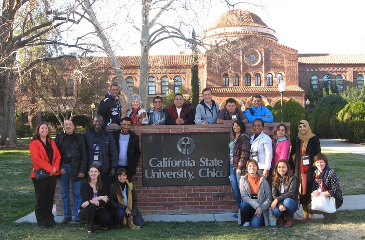 International teachers in front of CSU Chico sign at Kendall Hall