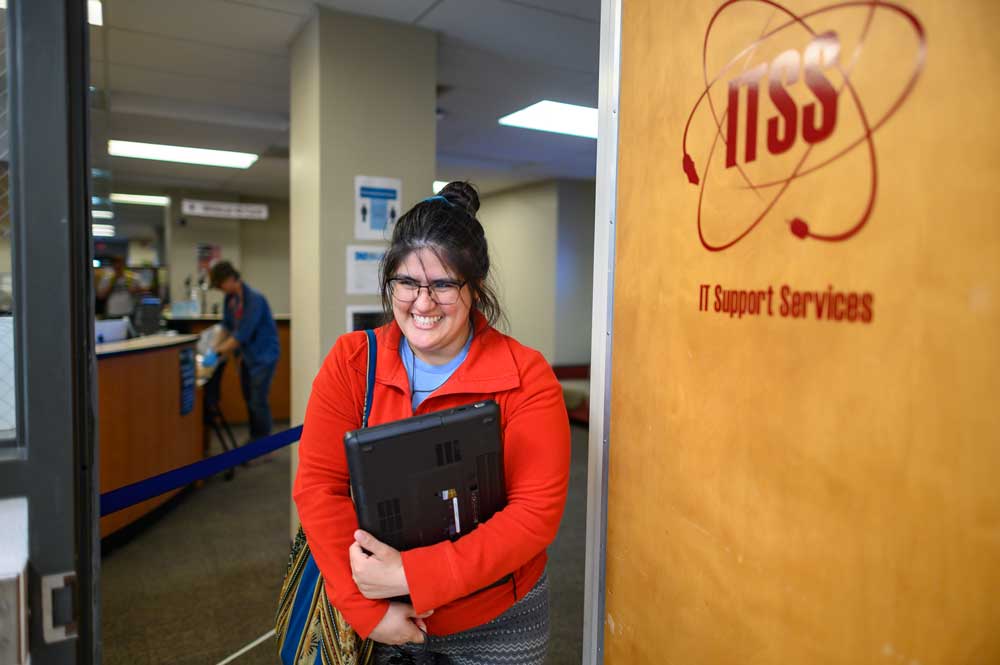 Student Lucia Anda logs into a laptop that was recently reimaged to be loaned as IT Support Services provide comprehensive technology support, including laptop loans and virtual technology assistance as the campus community adjust to suspension of in-person instruction due to impacts of the coronavirus pandemic