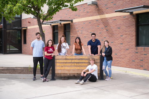 students outside Yolo hall sign