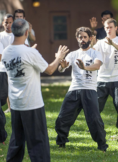 Instructor teaching tai-chi to a group of students