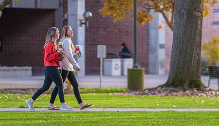 Students walk past Fall colors through Glenn Lawn
