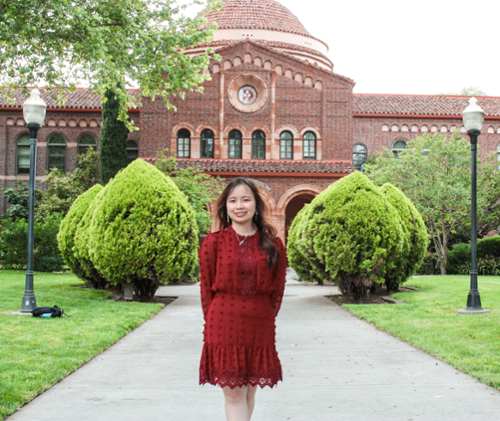 Emma Pham in front of Kendall Hall