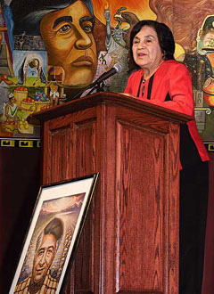 Dolores Huerta giving a speech in front of a podium 