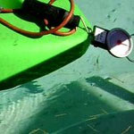 Back end of kayak in a pool attached to a hanging scale