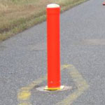 Orange cylinder in the center of a bike path