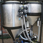 One larger and one smaller holding tank side-by-side and attached by hoses