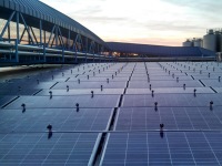 An array of rooftop solar panels at dusk