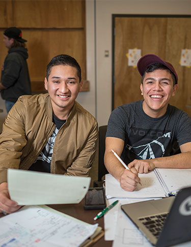 Two Students working and smiling