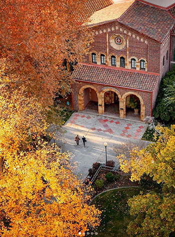 Vibrant fall leaves surround a view of Kendall Hall from above