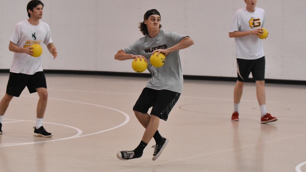 Person playing dodge ball, about to throw the ball.