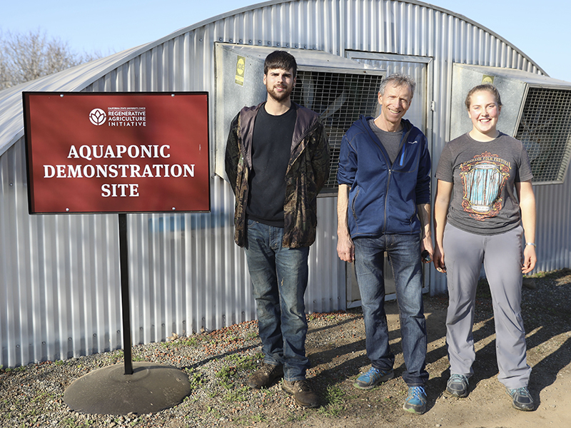 Students with professor Lee Altier in front of the Aquaponic Demonstration Unit.