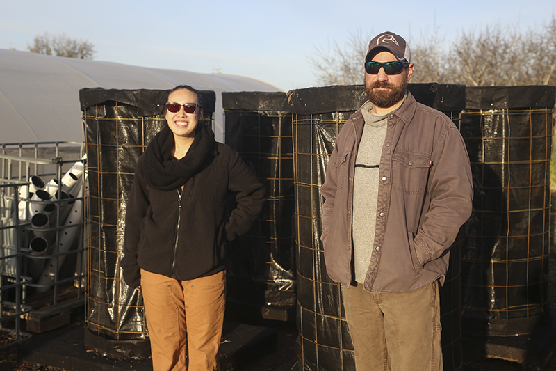 Student Research Intern Esther Kim and Research Assistant Vaughn Harold standing in front of the bioreactors they built.