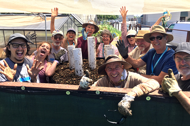 people celebrate having made their first Johnson Su compost bioreactor