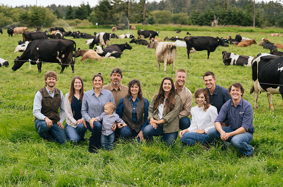 The Alexandre family with cows in the background.