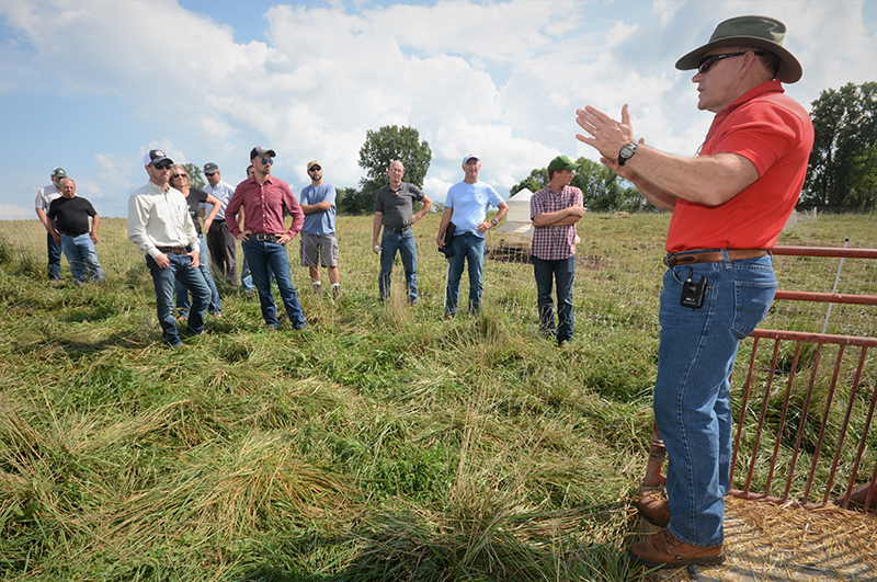 Allen Williams teaching class in a field with students