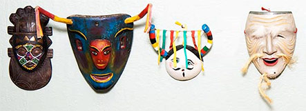 Masks from various cultures displayed on a wall