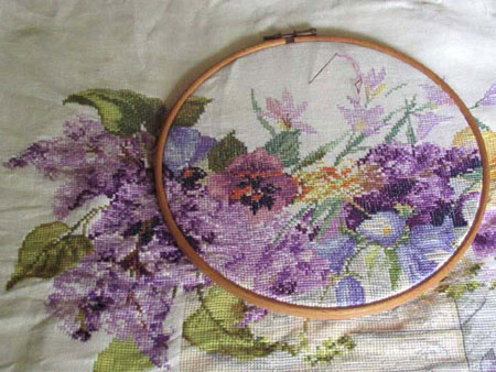 embroidery hoop with decorative flowers sewn in