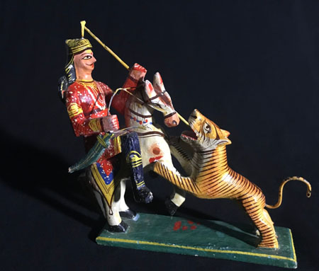 sculpture of man on horseback fighting a tiger
