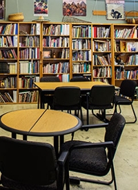Tables with chairs surrounded by bookcases