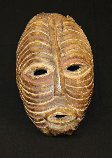 wooden mask decorated with pigment