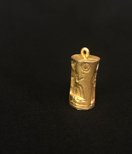small gold colored seal pendant