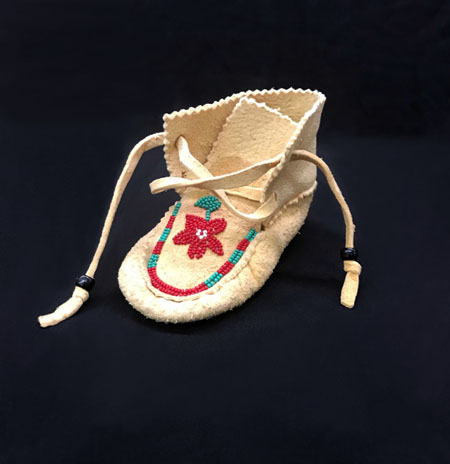 deer hide moccasin with red, green, and white seed beads