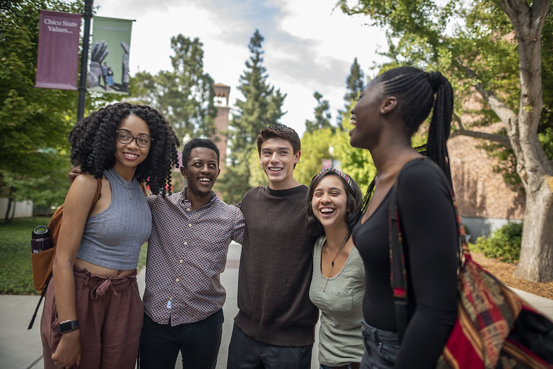 A group of students standing and smiling together.