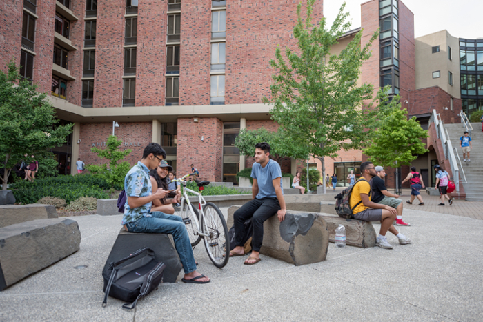 Students sitting outside of Whitney Hall.