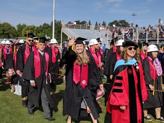 grads walking and waving