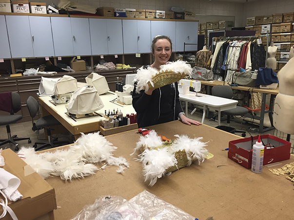 Costume assistant Emily Beets holding hats