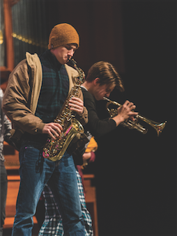 male student playing saxophone