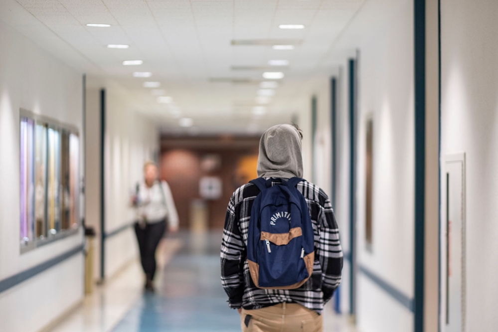 Student walking through hallway 