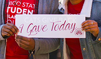 Students holding a sign that says "I Gave Today"