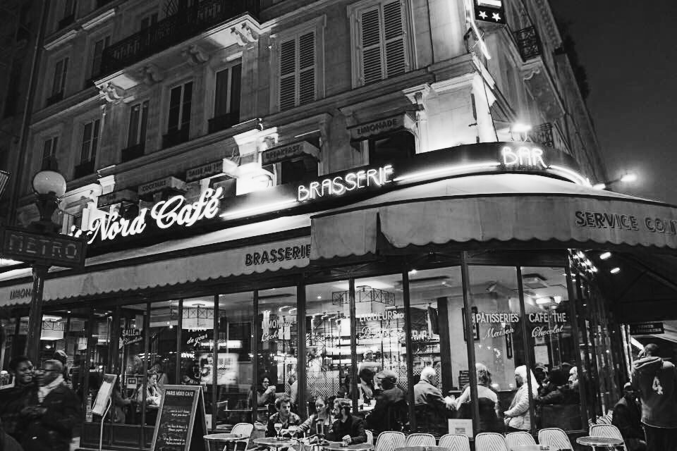 Black and white photo of a cafe in France